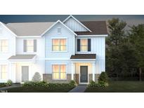 Charming two-story townhome with white siding, brick accents, and a welcoming front porch at 276 Fosterton Cottage Way, Raleigh, NC 27603