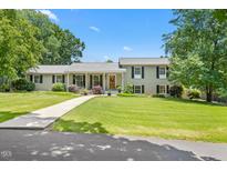 Charming home with a well-manicured lawn and inviting walkway leading to the covered front porch at 2816 Keck Dr, Burlington, NC 27215