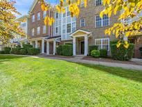 Charming brick townhome with well-manicured lawn and inviting entrance with mature landscaping at 3825 Cary Glen Blvd, Cary, NC 27519