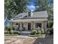 Charming home with stone-accented columns, a covered porch, and meticulous landscaping in a desirable neighborhood at 406 E Whitaker Mill Rd, Raleigh, NC 27608