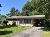 Traditional one-story brick home with an inviting front yard and convenient covered carport at 417 Sunnyview Rd, Henderson, NC 27536