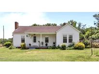 Charming single-story home with a quaint front porch and well-maintained lawn at 4240 Friendship Rock Creek Rd, Burlington, NC 27215