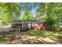 Charming single-story brick home featuring a covered front porch and a well-maintained lawn at 4412 Green Spring Dr, Garner, NC 27529