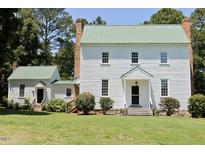 Charming two-story home with light green roof and an outbuilding perfect for workshop or storage at 4822 Nc Highway 98 W, Youngsville, NC 27596