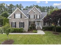 Charming two-story brick home with black shutters and lush landscaping at 501 Ivyshaw Rd, Cary, NC 27519