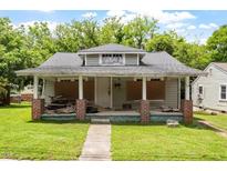 Dilapidated single-story home featuring a covered front porch needing significant repairs at 503 Edwards Dr, Chapel Hill, NC 27516