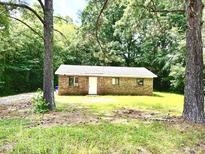 Cozy single-story brick house nestled among mature trees, offering a private, serene setting at 525 Locust Rd, Hillsborough, NC 27278