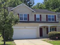 Two-story home with red shutters, a two-car garage, and a well-maintained front lawn at 6408 Bunker Hill Dr, Raleigh, NC 27610