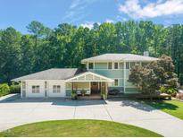 Charming two-story home with a three-car garage and welcoming front porch at 1209 Ravens Point Cir, Raleigh, NC 27614
