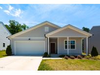 Charming single Gathering home with a two car garage and well manicured front lawn at 1444 Heron Pond St, Raleigh, NC 27604