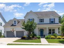 Charming two-story home featuring a well-manicured lawn, attached garage, and welcoming front porch at 1502 Spring Overlook Ln, Hillsborough, NC 27278