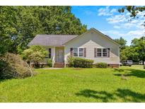 Charming home with a well-manicured lawn and inviting curb appeal at 209 E Church St, Creedmoor, NC 27522