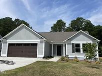 Charming single-story home with a two-car garage, and a welcoming front entrance at 265 Eason Creek Way, Clayton, NC 27527