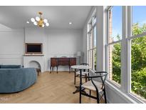 Bright living room with large windows, herringbone floors, and elegant furnishings at 320 W Martin St # 205, Raleigh, NC 27601