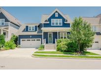 Charming navy blue home featuring a two-car garage and beautifully landscaped front yard at 41 Highveld Ave, Chapel Hill, NC 27516
