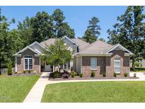 Charming brick home with well-manicured lawn and mature trees at 413 Great Smokey Mountain Dr, Mebane, NC 27302