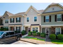 Townhomes feature manicured landscaping, covered entries, and visible house numbers for easy identification at 7809 Lillyhurst Dr, Raleigh, NC 27612