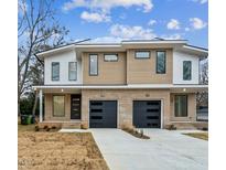 Modern duplex with brick accents, black garage doors, and a contemporary design under a partly cloudy sky at 810 Culpepper Ln, Raleigh, NC 27610