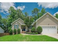 Charming single-Gathering home featuring a manicured lawn, tasteful landscaping, and a welcoming front porch at 90 Weatherly Dr, Franklinton, NC 27525