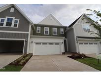 Charming new construction home featuring attached garages and manicured landscaping at 920 Montague Ave, Durham, NC 27703