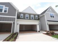 Attached garages with carriage doors provide convenient parking and complement the architectural style of the homes at 920 Montague Ave, Durham, NC 27703