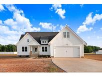 Charming two-story home with a two-car garage, dark roof, and light-colored siding at 9427 Turkey Way, Middlesex, NC 27557