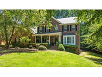 Beautiful brick home featuring a lush front yard and welcoming front porch at 1008 Old Meetinghouse Way, Raleigh, NC 27615