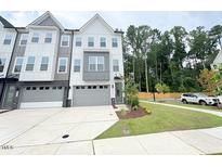 Modern townhome with a two-car garage, neutral color scheme and well-maintained landscaping at 1015 Regalia Rd # 27, Durham, NC 27713