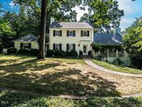 Traditional two-story home with a brick walkway, manicured landscaping, and charming curb appeal at 1512 St. Mary'S St, Raleigh, NC 27608