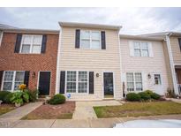 Charming townhome with classic architecture and well-maintained landscaping at 19 Cheltenham Dr, Clayton, NC 27520