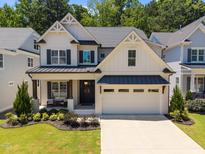 Charming two-story home showcasing a welcoming front porch and well-manicured landscaping at 3057 Eden Harbor Ct, Raleigh, NC 27613