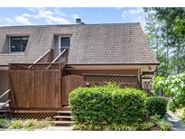 Charming exterior view of a two-story home with a wood fence and stairs leading to the front entrance at 346 Summerwalk Cir, Chapel Hill, NC 27517