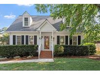 Charming two-story home featuring a brick walkway, manicured landscaping, and a classic architectural design at 5908 Danville Dr, Raleigh, NC 27612