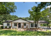 Charming ranch home with a brick facade, covered entrance, and well-manicured lawn at 6005 Lake Wheeler Rd, Raleigh, NC 27603