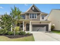Charming two-story home featuring a well-manicured lawn and a two-car garage in a desirable neighborhood at 634 Stapleford Ln, Fuquay Varina, NC 27526