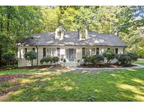 Charming home featuring a landscaped front yard and a classic architectural design at 701 Bennington Dr, Raleigh, NC 27615