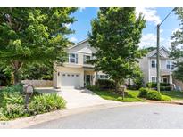 Charming two-story home featuring a well-manicured lawn, inviting curb appeal, and an attached two-car garage at 822 Blue Lake Dr, Mebane, NC 27302