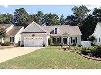 Charming single-story home featuring a two-car garage, well-manicured lawn, and inviting landscaping at 904 E Ivy Valley Dr, Fuquay Varina, NC 27526