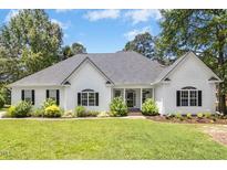 Charming one-story home with a manicured lawn and mature landscaping enhancing its curb appeal at 904 Parkridge Dr, Clayton, NC 27527