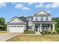 Beautiful two-story home featuring a covered front porch, attached garage, and well-maintained landscaping at 93 Kinsale Ct, Garner, NC 27529