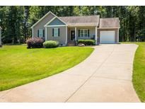Charming single-story home with a well-manicured lawn and an attached one-car garage at 102 Bluegrass Dr, Oxford, NC 27565