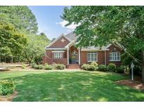 Charming brick home featuring a well-manicured lawn, beautiful landscaping, and inviting front entrance at 109 Fox Trap Ct, Garner, NC 27529