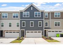Beautifully designed townhome featuring modern architecture and well-maintained landscaping at 1114 Crossvine Trl, Durham, NC 27703