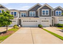 Charming townhome with a two-car garage and a well-manicured lawn in a desirable neighborhood at 150 Gosford Ln, Garner, NC 27529
