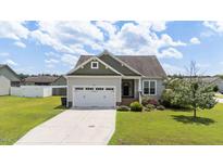 Charming single-Gathering home featuring a two-car garage, manicured lawn, and inviting curb appeal at 16 Woodglen Dr, Clayton, NC 27527