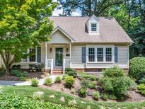 Charming home showcasing a well-maintained lawn and mature landscaping at 1708 Lake Park Dr, Raleigh, NC 27612