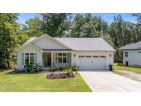 Charming single-Gathering home with tidy landscaping, a two-car garage, and delightful curb appeal at 174 Sequoia Dr, Louisburg, NC 27549