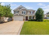 Charming two-story home featuring a welcoming front porch and attached two-car garage at 200 Woodvale Way, Fuquay Varina, NC 27526
