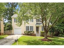 Charming two-story home features a manicured lawn, inviting entrance, and attached garage at 205 Mint Hill Dr, Cary, NC 27519