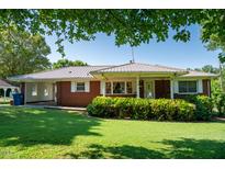 Charming one-story brick home with lush green lawn and covered porch at 2081 Stone Street Ext, Mebane, NC 27302